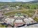 Aerial view of a modern commercial complex with structured parking, landscaped areas, and surrounding roadways at 1095 Lanier Pl, Cumming, GA 30041