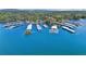 Expansive aerial view of boat docks on a scenic lake surrounded by lush forests and rolling hills at 1095 Lanier Pl, Cumming, GA 30041