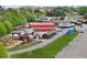 Aerial view of a charming farm and recreational area, complete with rustic buildings and ample parking at 1095 Lanier Pl, Cumming, GA 30041
