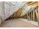 Unfinished attic space featuring exposed beams and spray foam insulation at 1095 Lanier Pl, Cumming, GA 30041