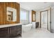 Modern bathroom with wood accent wall, a soaking tub, and dual vanities at 1095 Lanier Pl, Cumming, GA 30041