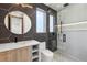 Modern bathroom with stylish vanity, hexagon tile, and glass shower door at 1095 Lanier Pl, Cumming, GA 30041
