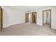 Bright bedroom features neutral carpet, white walls, and warm wood trim and doors throughout at 1095 Lanier Pl, Cumming, GA 30041