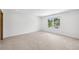 Bright, carpeted bedroom with a window view, offering a peaceful retreat at 1095 Lanier Pl, Cumming, GA 30041
