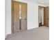 Bright bedroom features neutral carpet, white walls, and warm wood trim and doors throughout at 1095 Lanier Pl, Cumming, GA 30041
