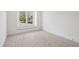 Bright bedroom features neutral carpet, white walls, and large window at 1095 Lanier Pl, Cumming, GA 30041