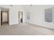 Spacious bedroom with plush carpet, neutral walls, and natural light from large windows at 1095 Lanier Pl, Cumming, GA 30041