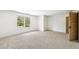 Bright bedroom with a large window offering scenic outdoor views and a stylish light wood door at 1095 Lanier Pl, Cumming, GA 30041