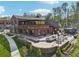Exterior view of Crooked Culture Brewing with inviting outdoor seating areas and lush landscaping around building at 1095 Lanier Pl, Cumming, GA 30041