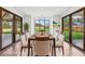 Staged dining room featuring hardwood floors, large windows, and backyard views at 1095 Lanier Pl, Cumming, GA 30041