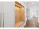 Entryway features custom hall tree with a wood bench and trim lighting in the cubby spaces at 1095 Lanier Pl, Cumming, GA 30041