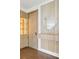Stylish entryway featuring wood accents, sleek shelving with lighting, and a decorative mirror, creating a welcoming and modern aesthetic at 1095 Lanier Pl, Cumming, GA 30041