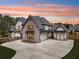 Stunning two-story home with a brick and white exterior, gray roof, and a spacious driveway at 1095 Lanier Pl, Cumming, GA 30041