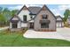 Charming two-story home with stone and siding, complemented by a well-manicured lawn and fresh landscaping at 1095 Lanier Pl, Cumming, GA 30041