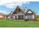 Spacious backyard with covered patio and a view of the home's architectural features and design at 1095 Lanier Pl, Cumming, GA 30041