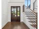Inviting foyer with rich hardwood floors, a modern staircase, and a large glass-paneled front door at 1095 Lanier Pl, Cumming, GA 30041