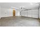 Bright two-car garage with sealed concrete floor, white walls and trim, and exterior access door at 1095 Lanier Pl, Cumming, GA 30041