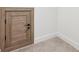 Hallway features neutral carpet, white walls, a small door, and warm wood trim at 1095 Lanier Pl, Cumming, GA 30041