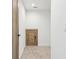Hallway features neutral carpet, white walls, a small door, and warm wood trim at 1095 Lanier Pl, Cumming, GA 30041