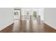 Upstairs hallway with sleek wood flooring and modern railing, leads to rooms with beautiful windows at 1095 Lanier Pl, Cumming, GA 30041
