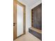 Bright hallway featuring a glass paneled door, custom storage cabinets with open shelves, and a built-in bench at 1095 Lanier Pl, Cumming, GA 30041