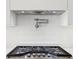 Close up of the black stovetop and pot filler in the new kitchen at 1095 Lanier Pl, Cumming, GA 30041