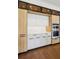 Modern kitchen featuring stainless steel appliances, wood and white cabinets, and recessed lighting at 1095 Lanier Pl, Cumming, GA 30041