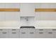 Modern kitchen with clean white cabinets, stainless steel appliances, and sleek countertops at 1095 Lanier Pl, Cumming, GA 30041