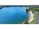 Scenic lake view featuring a sandy beach, clear blue water, and lush green trees surrounding the shoreline at 1095 Lanier Pl, Cumming, GA 30041
