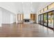 Open living room featuring a stone fireplace, high ceilings, and folding glass doors to the backyard at 1095 Lanier Pl, Cumming, GA 30041