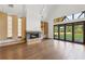Bright living room with a stone fireplace, high ceilings, and large windows opening to the backyard at 1095 Lanier Pl, Cumming, GA 30041