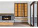 Inviting living room with a stone fireplace, and a custom glass door display cabinet at 1095 Lanier Pl, Cumming, GA 30041
