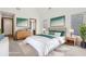 Bright main bedroom with a plush king bed, light wood floors, and stylish decor at 1095 Lanier Pl, Cumming, GA 30041