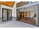 Covered patio with folding glass doors open to great room, wood ceiling, and brick accents at 1095 Lanier Pl, Cumming, GA 30041