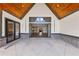 Covered outdoor patio with wood ceiling, gray brick accents, and foldable glass doors to the interior at 1095 Lanier Pl, Cumming, GA 30041