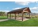 A spacious wooden pavilion with picnic tables offering a shady gathering spot within a serene outdoor setting at 1095 Lanier Pl, Cumming, GA 30041