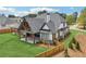 Scenic backyard featuring a covered patio and spacious lawn, providing a serene and private outdoor retreat for relaxation and leisure at 1095 Lanier Pl, Cumming, GA 30041