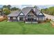 Beautiful backyard view of home with a large lawn and covered porch, ideal for enjoying the outdoors with Gathering and friends at 1095 Lanier Pl, Cumming, GA 30041