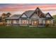 Expansive backyard featuring a covered patio with wood columns and an outdoor living space at 1095 Lanier Pl, Cumming, GA 30041