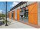 Retail storefronts featuring large wooden sliding doors and modern design elements along a well-maintained sidewalk at 1095 Lanier Pl, Cumming, GA 30041