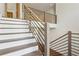Modern staircase with sleek metal railings, wooden treads, and a bright, open design at 1095 Lanier Pl, Cumming, GA 30041