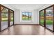 Bright sun room with hardwood floors, large windows with views of the landscaped backyard at 1095 Lanier Pl, Cumming, GA 30041
