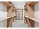 Spacious walk-in closet with custom built-in wood shelving and carpet flooring at 1095 Lanier Pl, Cumming, GA 30041