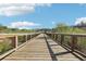Scenic wooden bridge with metal railings, offering picturesque views of the surrounding natural landscape at 1095 Lanier Pl, Cumming, GA 30041