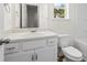 Bright bathroom featuring a vanity, mirror, and a toilet at 136 Grant Dr, Canton, GA 30114