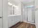 Well-lit bathroom with double vanity and a glass-enclosed shower at 136 Grant Dr, Canton, GA 30114