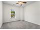 Bright bedroom with a ceiling fan and large window offering views of the neighborhood at 136 Grant Dr, Canton, GA 30114