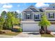 Two-story home with gray siding, two-car garage, and landscaped front yard at 136 Grant Dr, Canton, GA 30114