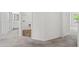 Hallway with neutral carpet, leading to the laundry room and bathroom at 136 Grant Dr, Canton, GA 30114