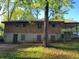 View of backyard shows the exterior elevation and enclosed porch at 1888 Delphine Dr, Decatur, GA 30032